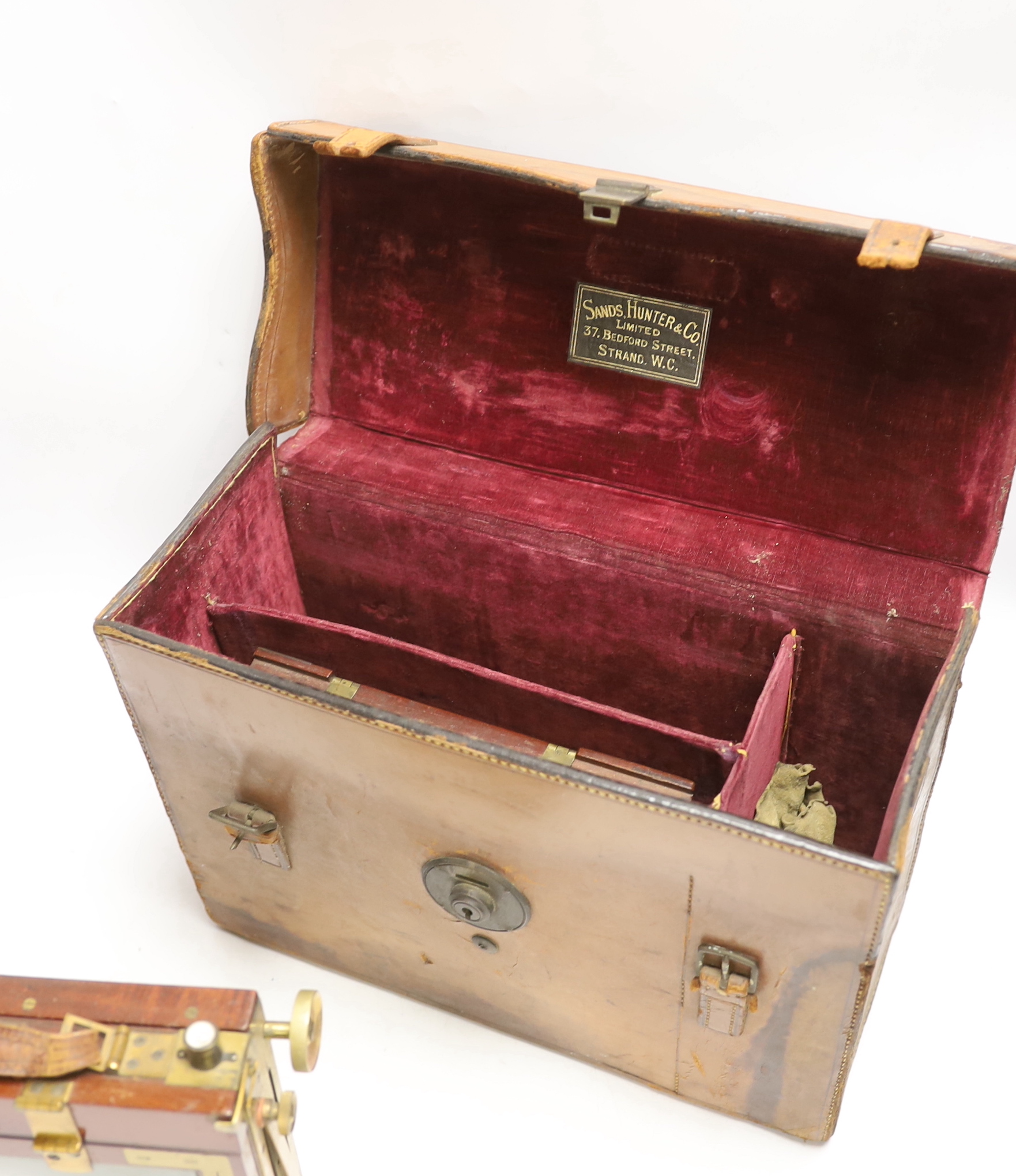 An early 20th century half plate camera by Sands, Hunter & Co. 37 Bedford Street, Strand, London WC, mahogany and brass frame, body 21 x 20cm, in the original leather case, also containing a Taylor, Taylor & Hobson Ltd.